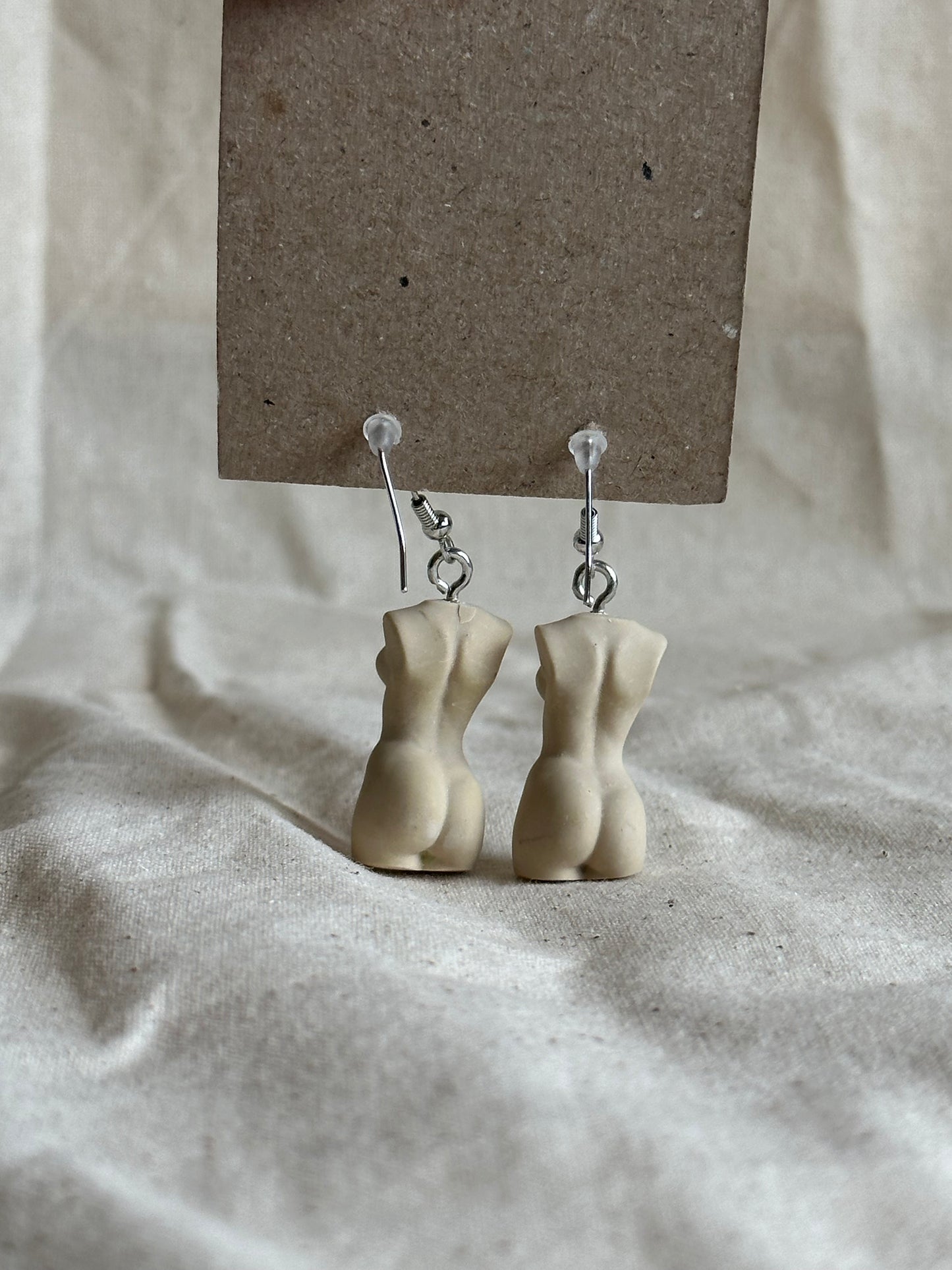 Slim female body earrings in beige - silver hooks