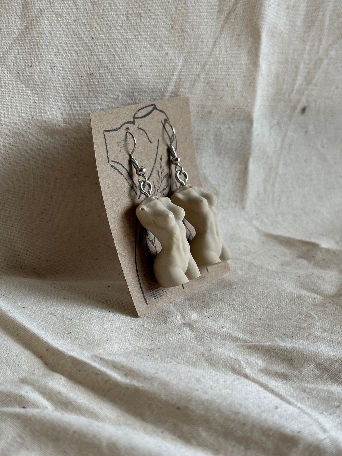 Slim female body earrings in beige - silver hooks