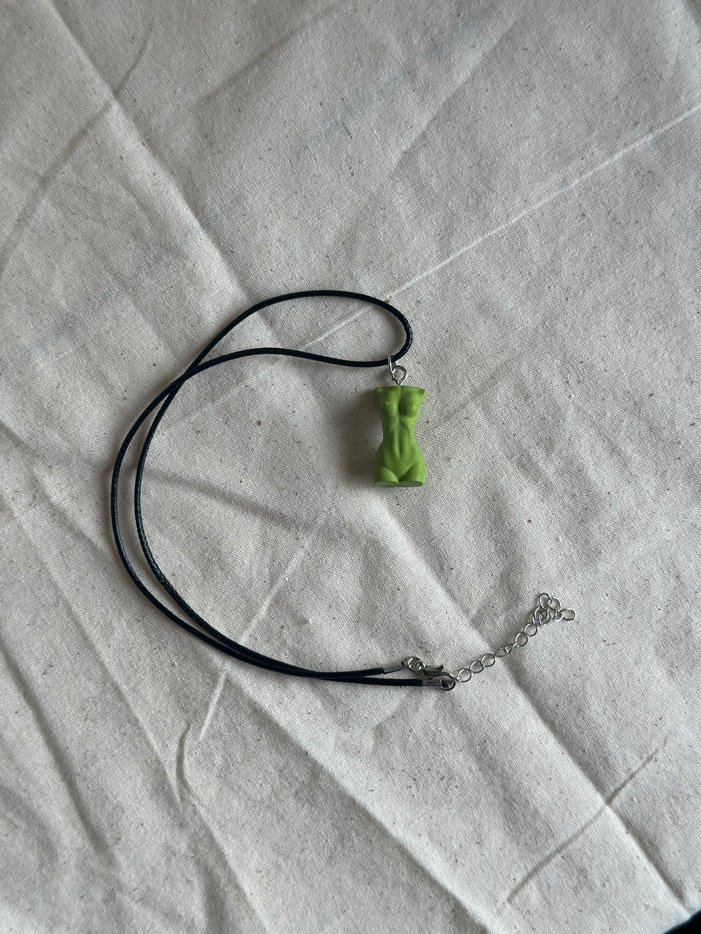 Slim female body necklace in green - black cord