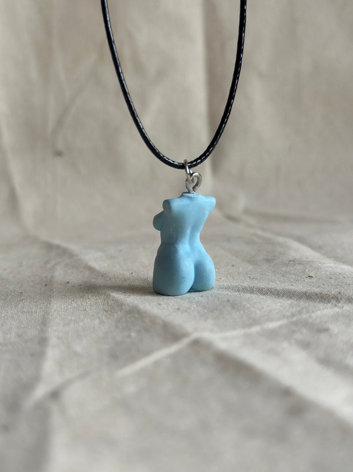 Plus size female body necklace in light blue - black cord