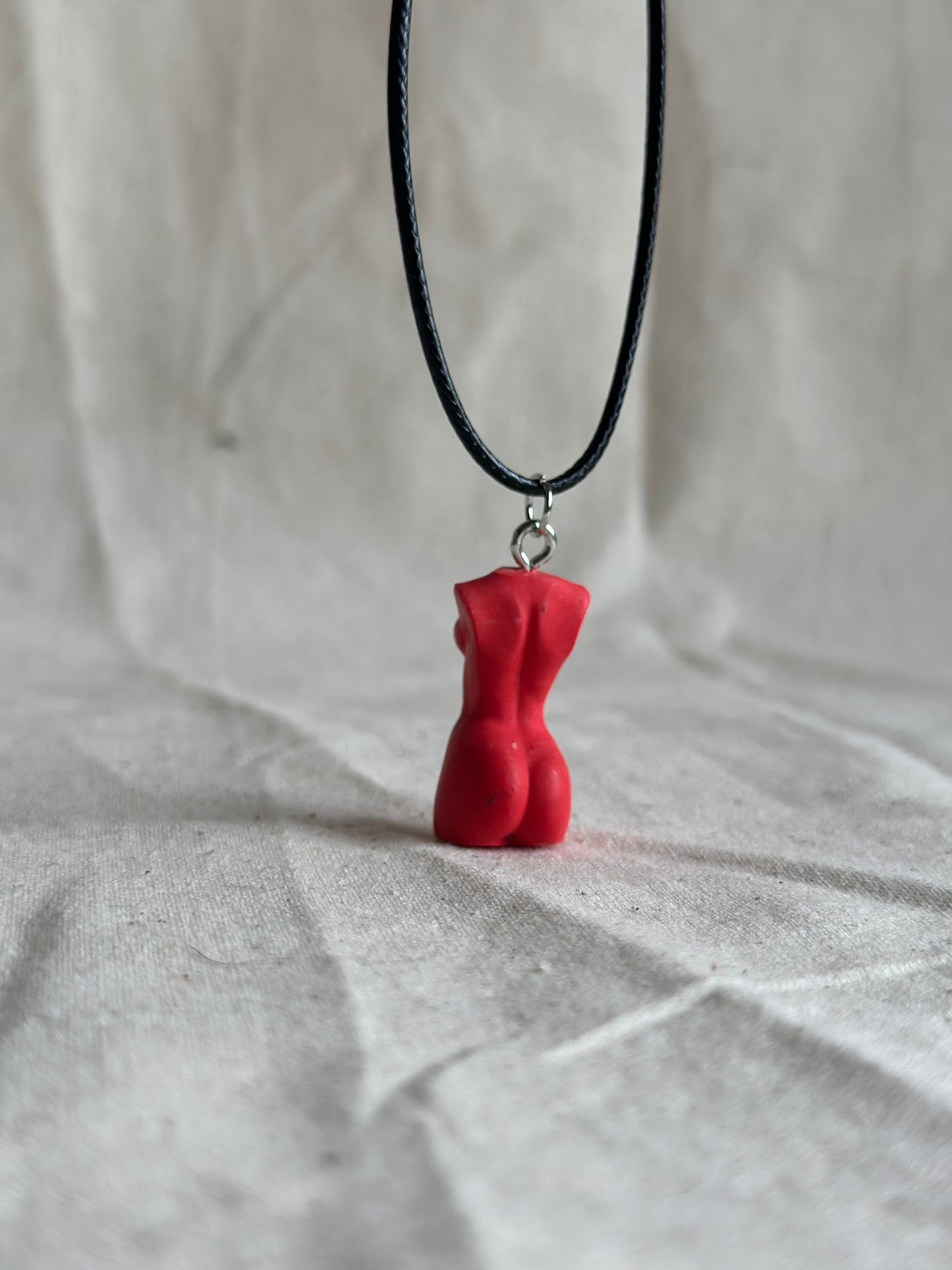 Slim female body necklace in red - black cord