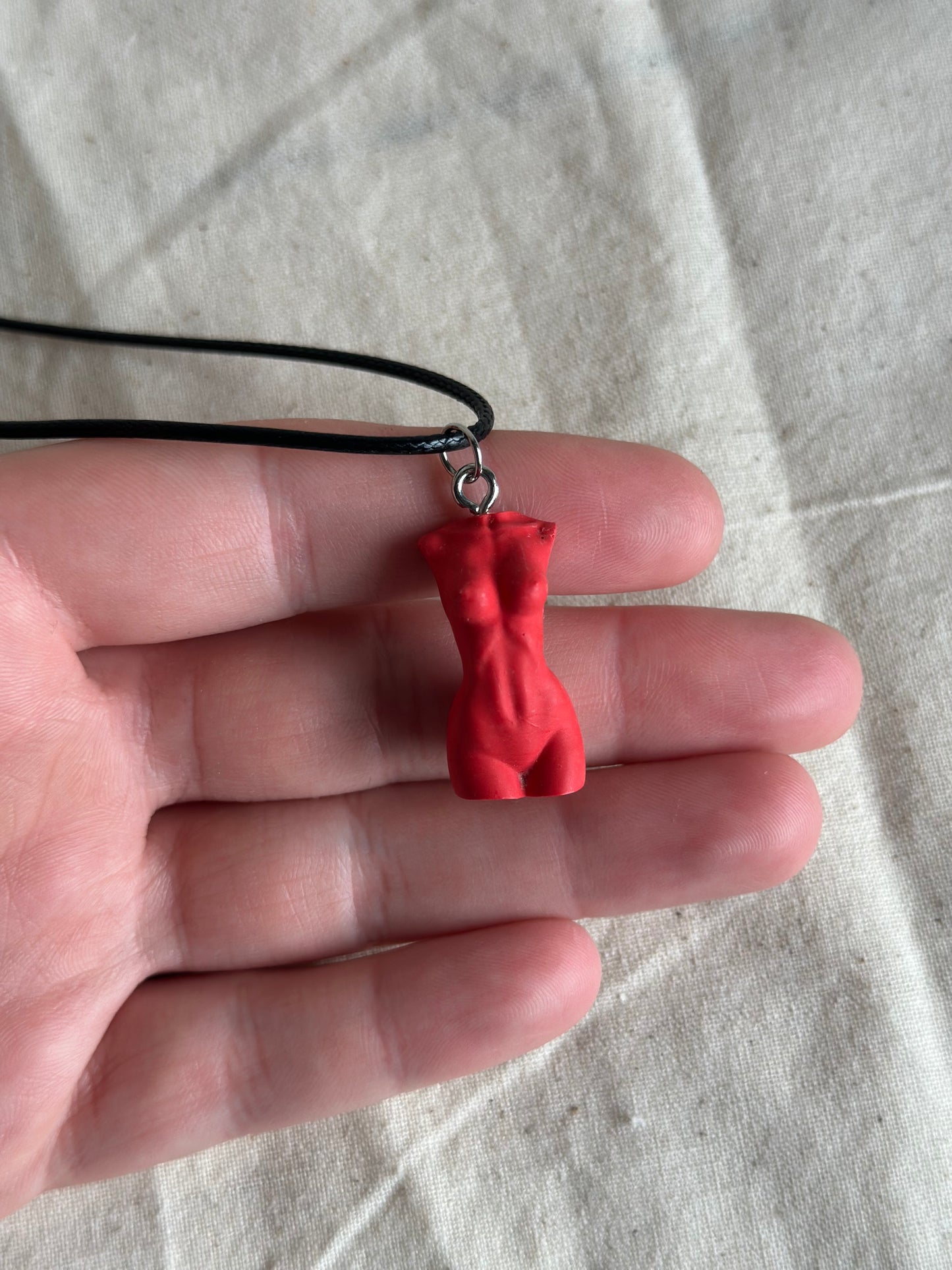 Slim female body necklace in red - black cord