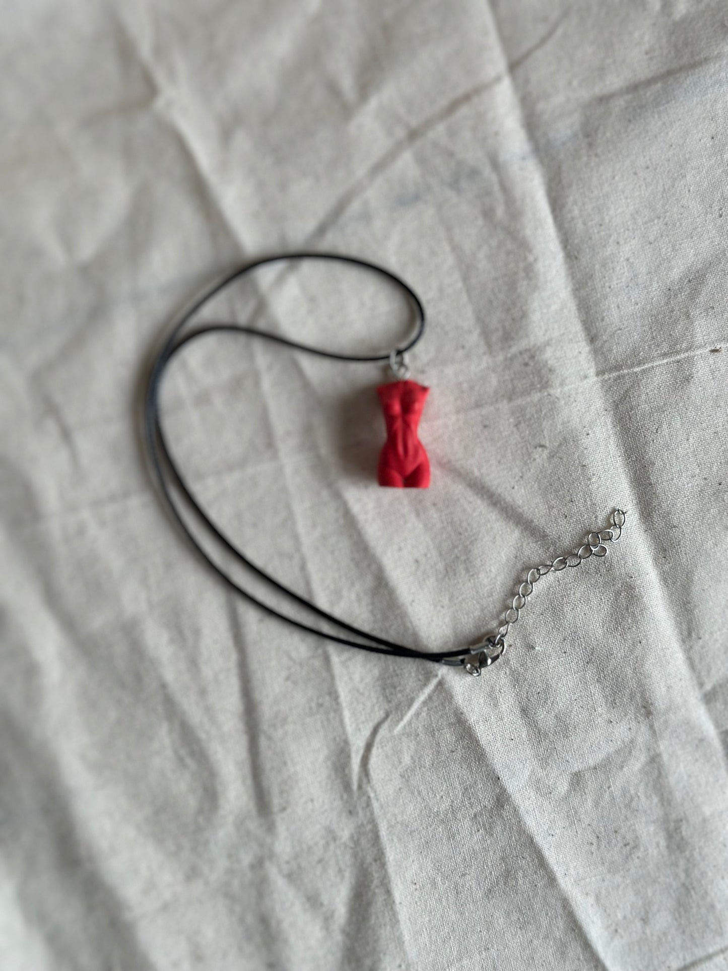 Slim female body necklace in red - black cord